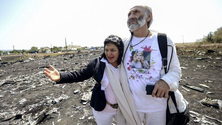 "A small possibility": The Dyczynskis at the MH17 crash site in eastern Ukraine. Photo: AFP