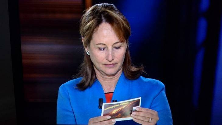 French Environment Minister Segolene Royal reading the Environment Victoria postcard calling for Hazelwood to be shut.