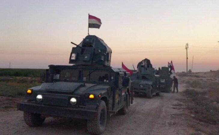 This image made from a video shows Iraqi soldiers on military vehicles in the Qatash area towards Kirkuk gas plant, south of Kirkuk, Iraq, Monday, Oct. 16, 2017.  Iraqi state media say federal troops have entered disputed territories occupied by the nation's Kurds. The move comes three years after Kurdish militias seized the areas outside their autonomous region to defend against an advance by the Islamic State extremist group. (APTN via AP)