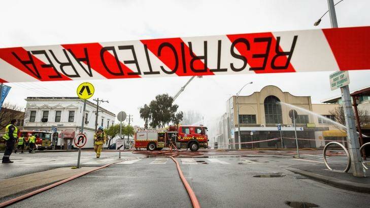 Firefighters on Bay Street, Port Melbourne, on Sunday morning. Photo: Chris Hopkins