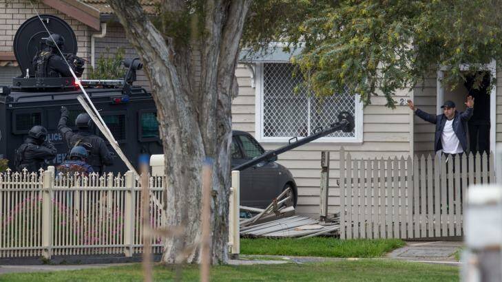 A man comes out of a house after a stand-off with police. Photo: Jason South