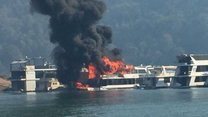 Flames engulf the house boat. Photo: Courtesy Seven News, via Twitter