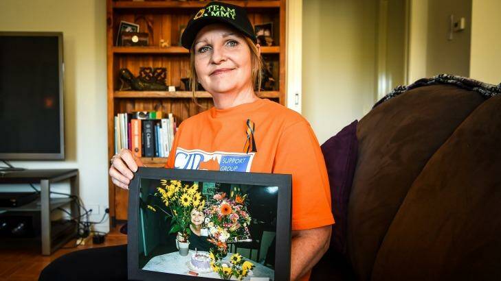 Nicolle Ward with a picture of her mother Pamela Thomas, who died from Creutzfeldt-Jakob disease in 2000. Photo: Justin McManus. 