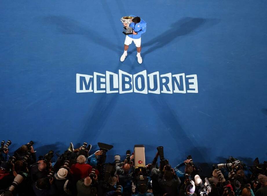 King of the court: Novak Djokovic poses with the Norman Brookes Trophy after beating Andy Murray to the 2015 Australian Open crown. Photo: William West