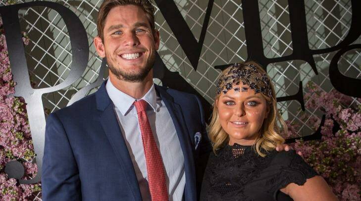 Geelong player Tom Hawkins and his wife, Emma, are celebrating the return of Emma's stolen wedding dresses. Photo: Chris Hopkins
