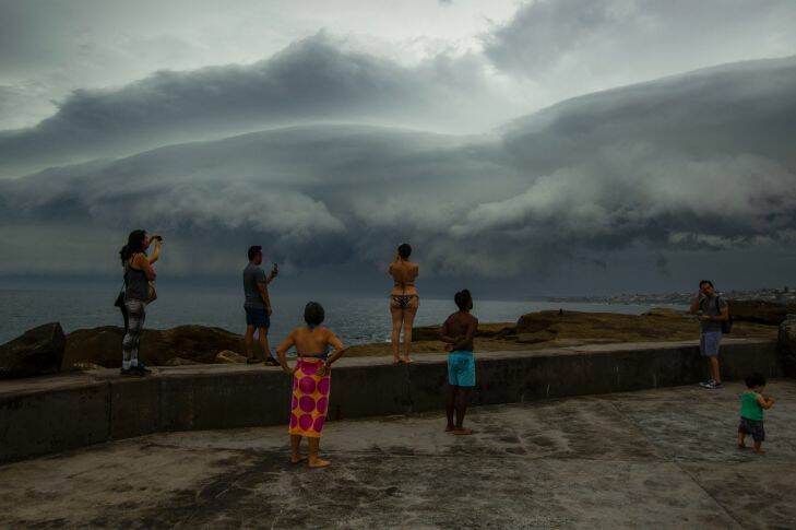 SMH. Weather generic. 9th of January 2018. People watch as a storm approaches Clovelly from the south. Photo: Dominic Lorrimer