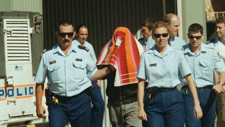 Stephen James Boney is led by police to Moree Local Court after being charged with rape in April 2000. Photo: Andrew Meares