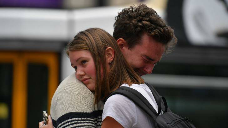 People console each other in the Bourke Street Mall. Photo: Eddie Jim