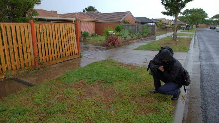 A television cameraman films the scene of the shooting in Walsingham Crescent in Kurunjang. Photo: Jason South