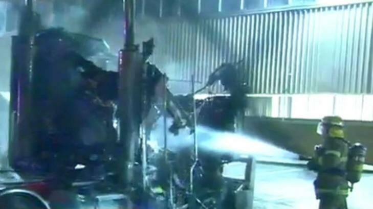 Firefighter extinguishing the flames after five trucks were on fire. Photo: Twitter/@Sunriseon7