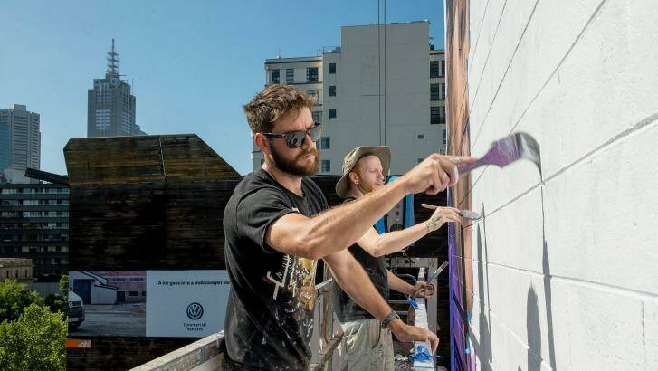 Artists Jason Parker and James Dewing  work on the Zoolander 2 mural. Photo: Jesse Marlow