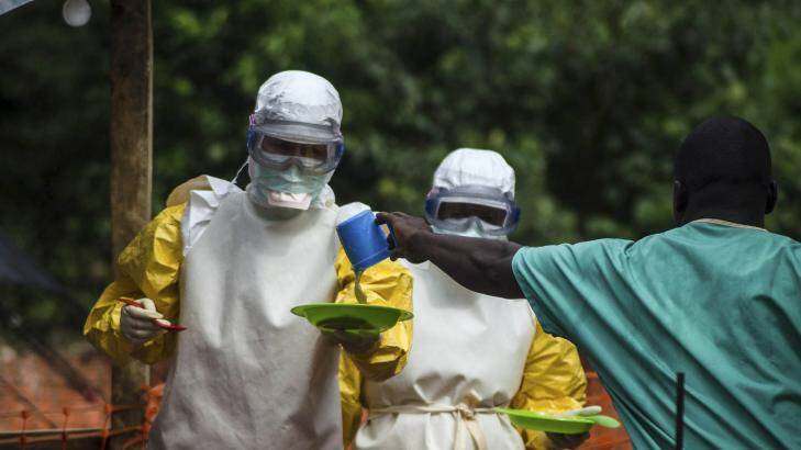Medical staff working with Medecins sans Frontieres (MSF) prepare to bring food to patients kept in an isolation area at the MSF Ebola treatment centre in Kailahun, Sierra Leone. Photo: Reuters