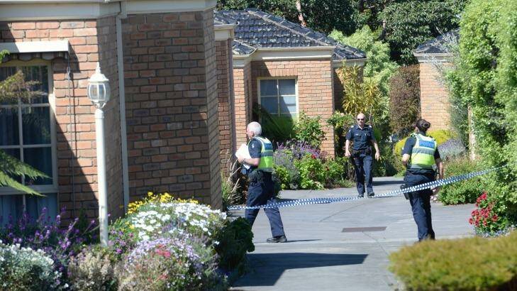Police outside the block of units in Mitcham, where a man's body was found. Photo: Justin McManus.