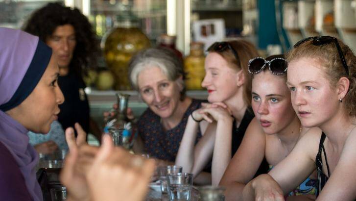 Cesca Falcini, 14 (with black and white sunglasses) and friend Alycia Eicke, 15, at the Moroccan Deli-cacy cafe in Brunswick taking part in Speed Date a Muslim, asking Muslim women about their faith and culture.  Photo: Penny Stephens