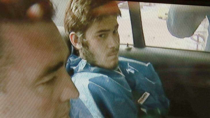 Sevdet Besim in the back of a police car after his arrest Photo: Channel 9