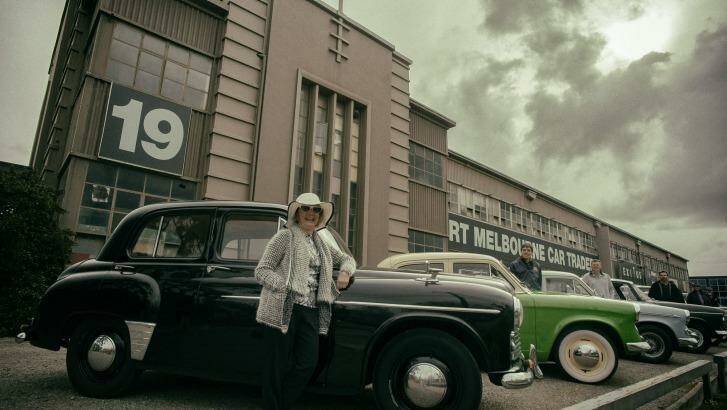 Margaret McKay rests on her 1951 Hillman Minx sedan in front of the old factory at 19 Salmon Street. Photo: Luis Ascui