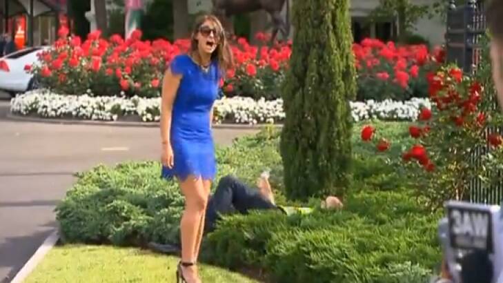 Sarah Finn looks back at the media, while Acting Superintendent Cooper lies in the juniper bushes. Photo: Channel Seven