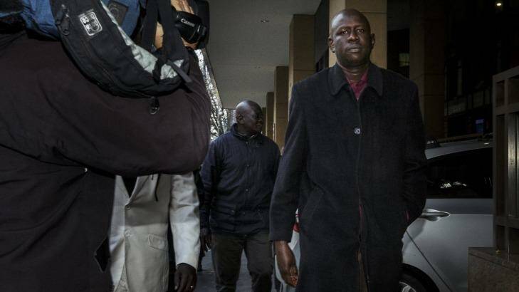 Joseph Tito Manyang, the father of the three children killed when the car went into the lake, outside Melbourne Magistrates Court on Monday. Photo: Daniel Pockett