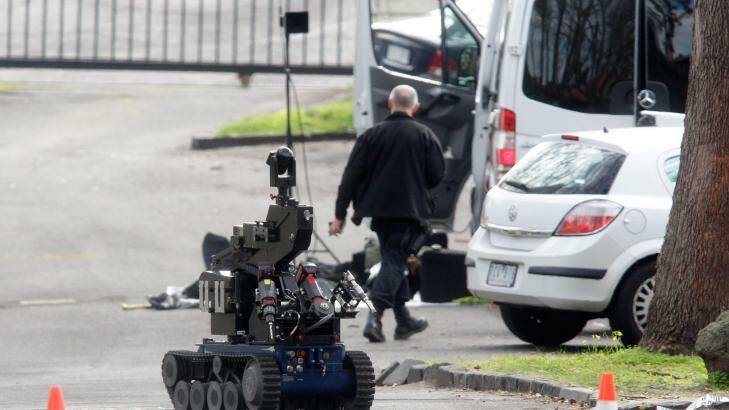 Police used a robot to examine a suspicious ute outside the evacuated school.