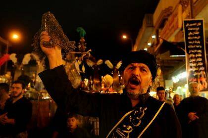 Centuries-old ritual: A Shiite Muslim man flagellates himself during an Ashura procession to the Shrine of Imam Musa al-Kadhim in Baghdad's northern suburb of Kadhimiya on Thursday. Photo: Kate Geraghty