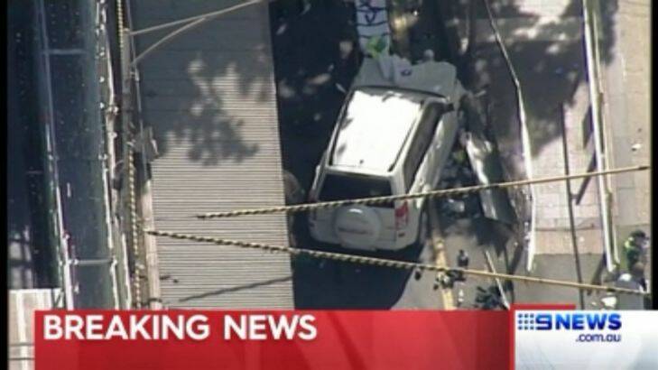 Emergency services tend to pedestrians outside of Flinders St Station who had been hit by a 4WD car. Credit: Nine News