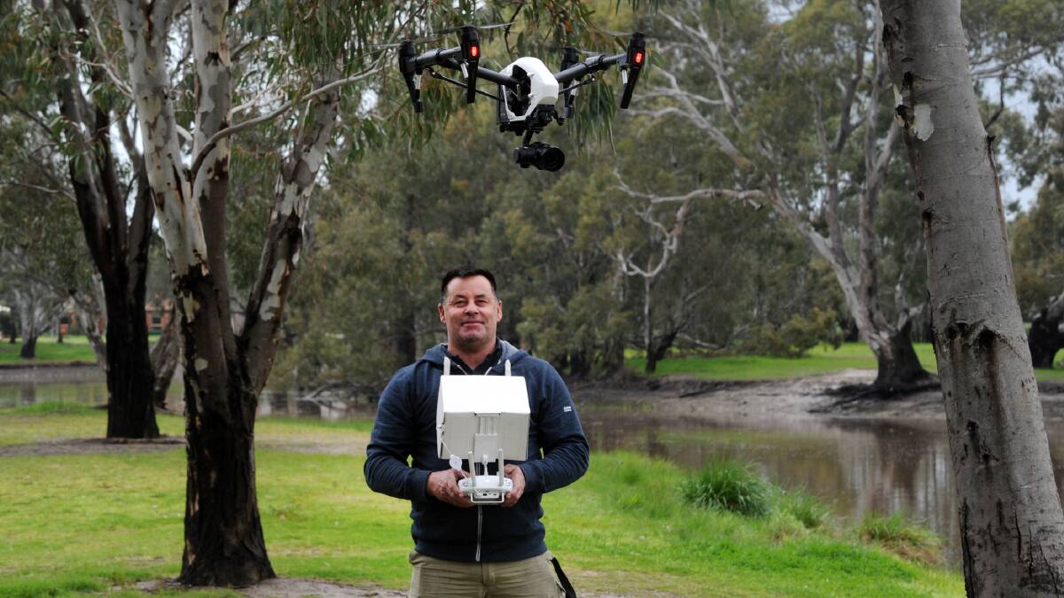 EYES IN THE SKY: Stephen Hughes of Australian Drone Mania, at Weir Park, Wimmera River. Picture: PAUL CARRACHER 