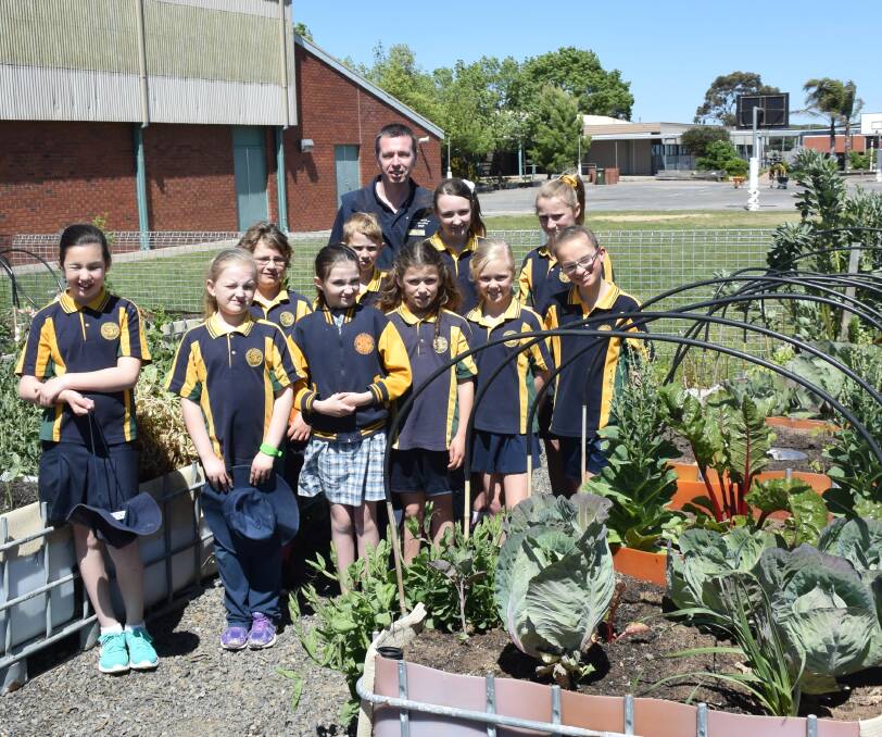 YOUNG GARDENERS: Horsham West Primary teacher Ben Tate with grade 4B during their weekly tedning of the vegetable garden.