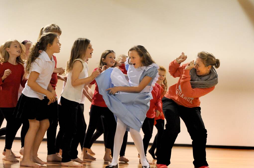 ON STAGE: Holy Trinity Lutheran School student Katelyn Busbridge plays Alice in the school’s musical ‘Through the Looking Glass’. 
She is pictured with choreographer Kylie Hermans and other students, from left, Jasmine Gould, Amy Milbourne, Angela Rudolph and Manisha Busbridge. Picture: SAMANTHA CAMARRI