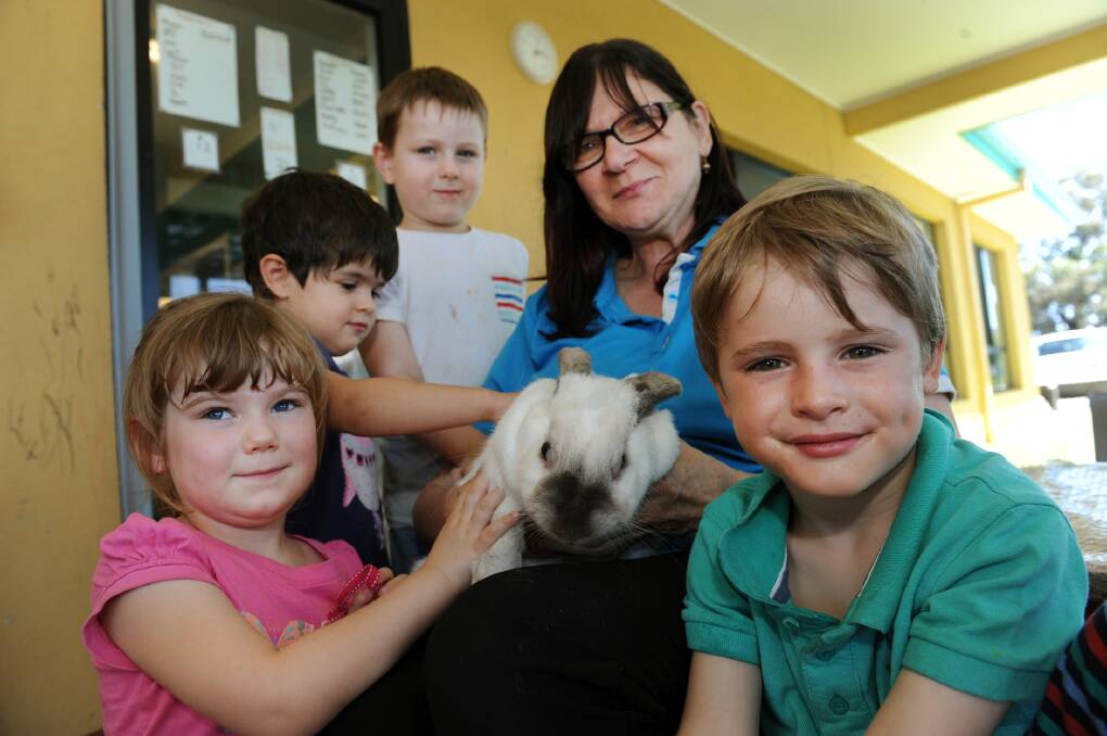 HOME IS WHERE THE HUTCH IS: Heidi Neighbour, Tara Farzan, Campbell Kershaw, Wendy Mackley and Thomas Penny are happy to see Poppy the rabbit back at Goodstart Early Learning Centre after she went missing. Picture: PAUL CARRACHE