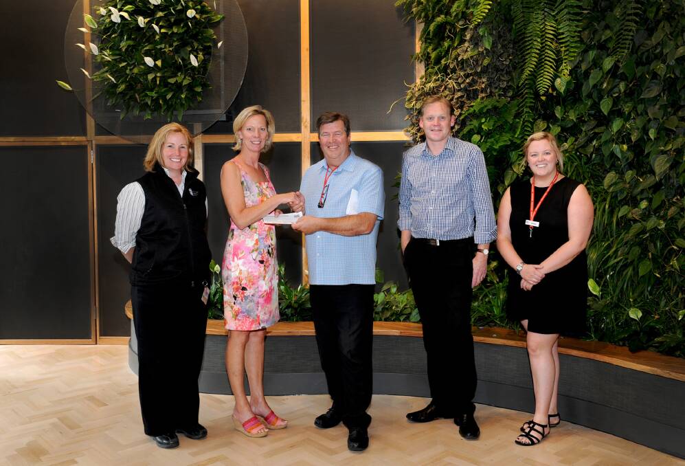 TARGET REACHED: Business Horsham executive administrator Wendy Mitchell, second from left, hands over a $1500 cheque to Wimmera Uniting Care staff, finalising the Target 365 homeless campaign. Pictured, from left, are Sandra McDonald, acting deputy
chief executive Alistair Houston, housing manager Paul Latimer and Emma Hynes. Picture: KELLY McRAE