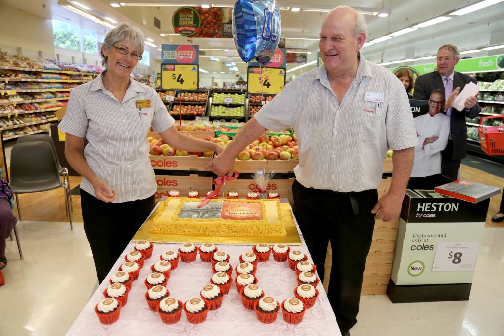 COLES TURNS 100: Horsham Coles stalwarts Norma McDonnell, who has worked for the store for 37 years, and Ian Kell, who has worked there for 42.5 years, cut a celebratory centenary cake on Wednesday. Picture: THEA PETRASS