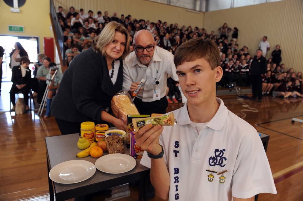 ALLERGY EVENT: Horsham’s St Brigid’s College year 12 student James McRae 
highlights food allergies during a school assembly with guest speakers Wimmera 
Base Hospital dietician Pam Marshman and hospital clinical educator Chris Dodson. 
 Picture: PAUL CARRACHER