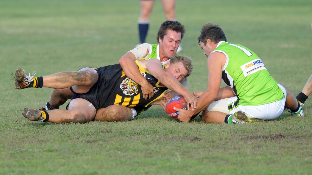 SCRAPPING IT OUT: Jeparit-Rainbow players Jake Perry, left, and Tom Clugston tackle Pimpinio's Dylan Baker on Saturday. The Storm recorded its first win as a member of the Horsham District Football Netball League. Picture: PAUL CARRACHER

Dylan Baker tackled by Jake Perry, left, and Tom Clugston, Pimpinio v Jeparit Rainbow.