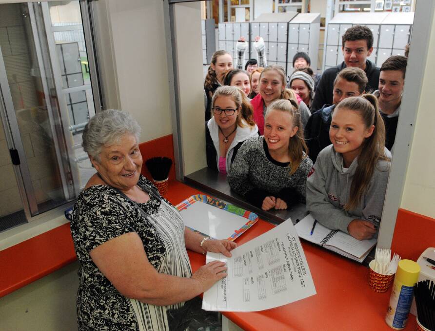 Marg McCluskey serves a large group of students on her last day in the St Brigid's College canteen. She is retiring after nearly three decades at the Horsham school. Picture: PAUL CARRACHER