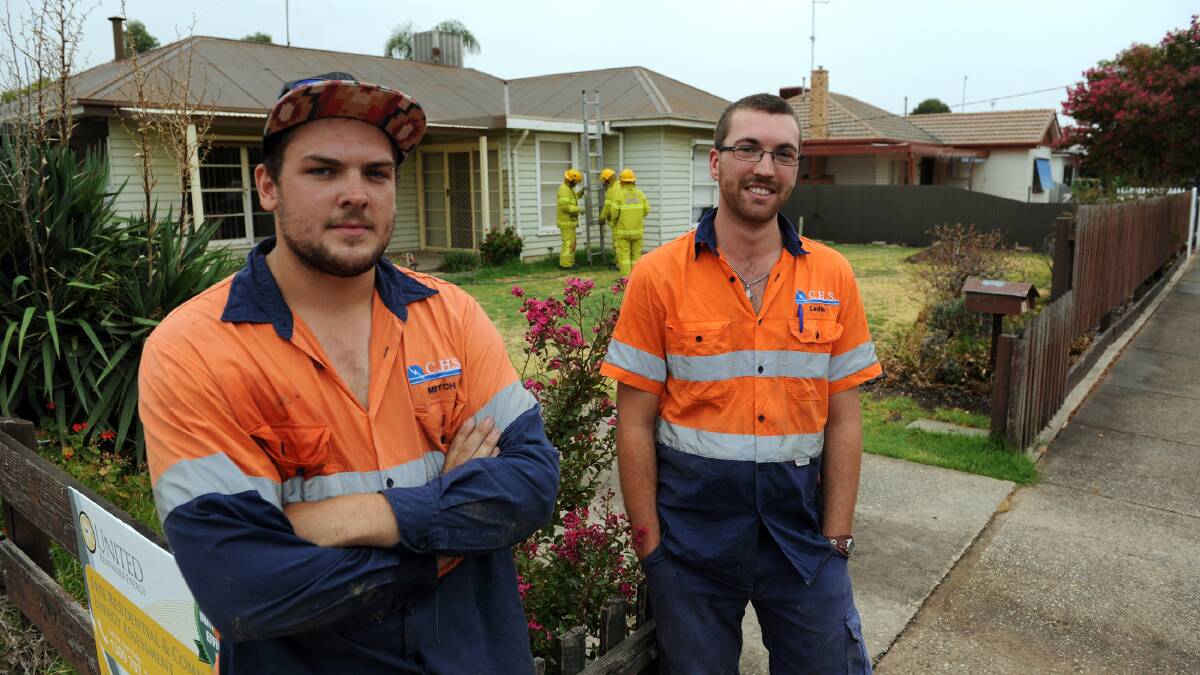 GOOD SAMARITANS: Horsham electricians Mitch Turner and Lachie Trigg put out a roof fire in Edith Street on Thursday. Picture: PAUL CARRACHER