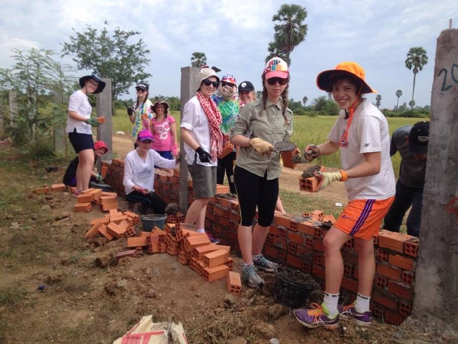 MAKING AN IMPACT: Mikaela Turvey, Felicity Fulcher, Bella Beddison, Jess Hill, Alana Young, Tayleka Hughes, Ash Sorrel, Mardi Isabel and Danielle Fogarty helped build a wall for Cambodian students during their alternate schoolies program. Picture: CONTRIBUTED