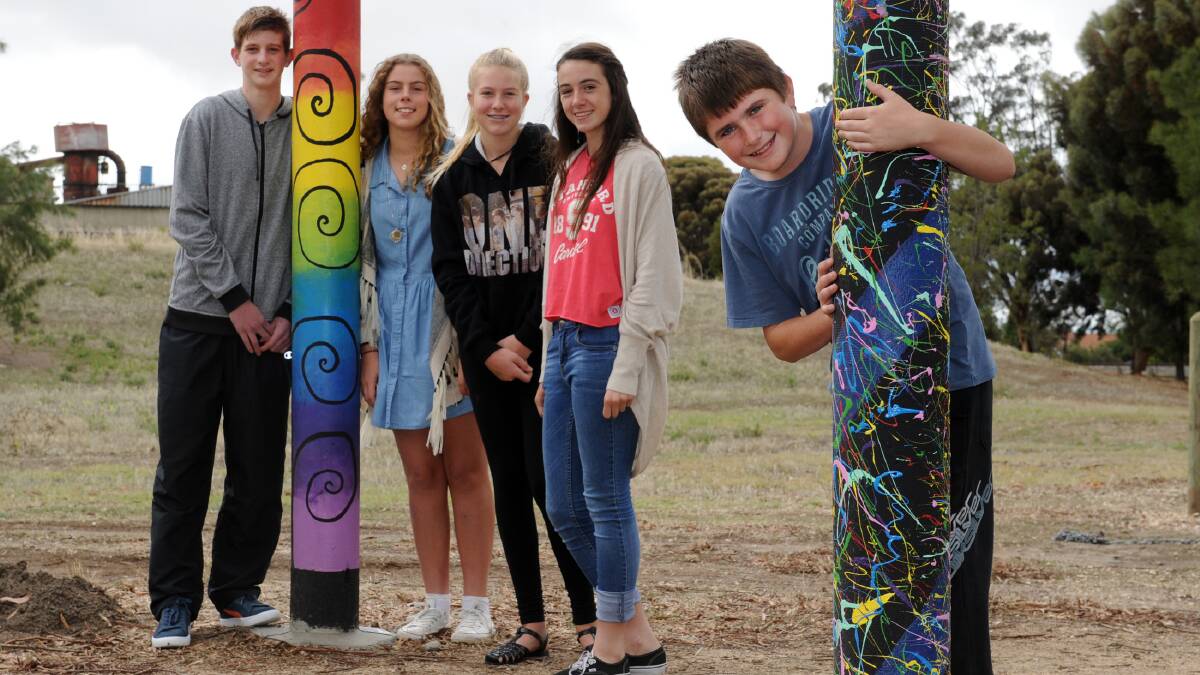 TOP DESIGNS: Eight new poles in Horsham's North Foundry Park were officially launched on Friday. The poles were designed by Northfest competition winners Dawson Cross, Olivia Delahunty, Bianca Drum and Anna Bush. Absent from their design team are Kaylee Schmidt and Miranda Hutchins. In the foreground is Brenton Hallam with his winning design. Absent are Robbie McAlpine and Jaidyn Liesfield. Picture: PAUL CARRACHER