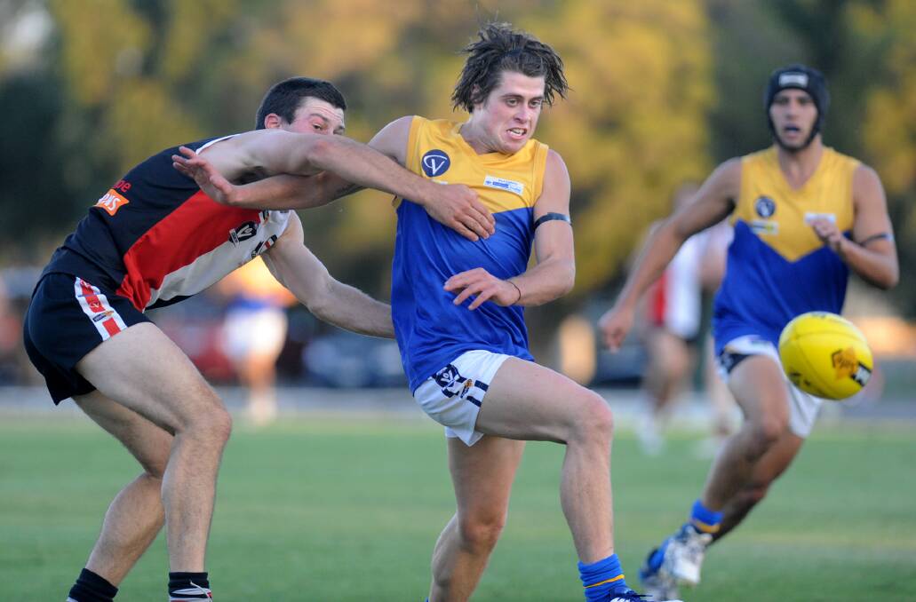 Natimuk United's Jay Barby gets a kick away against Edenhope-Apsley in round two. Picture: SAMANTHA CAMARRI
