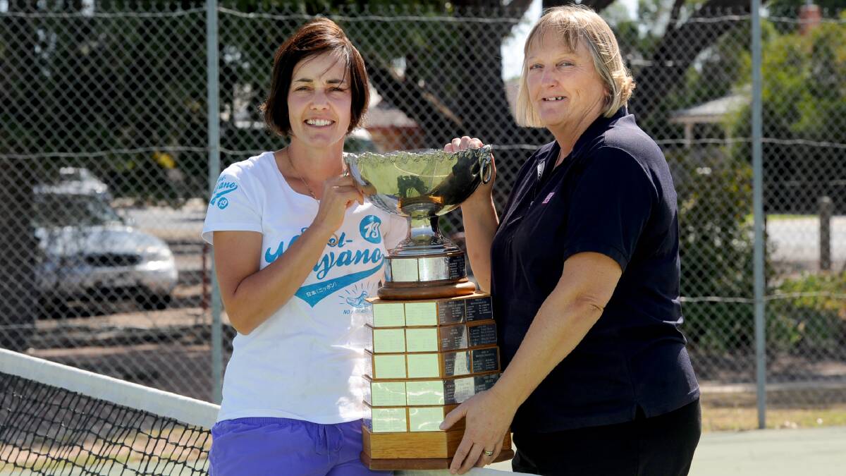 BATTLE: Drung South's Janelle Knight and Kalkee's Debbie Lawson pose with the Central Wimmera Tennis Association pennant premiership cup before their clash tomorrow. Picture: SAMANTHA CAMARRI