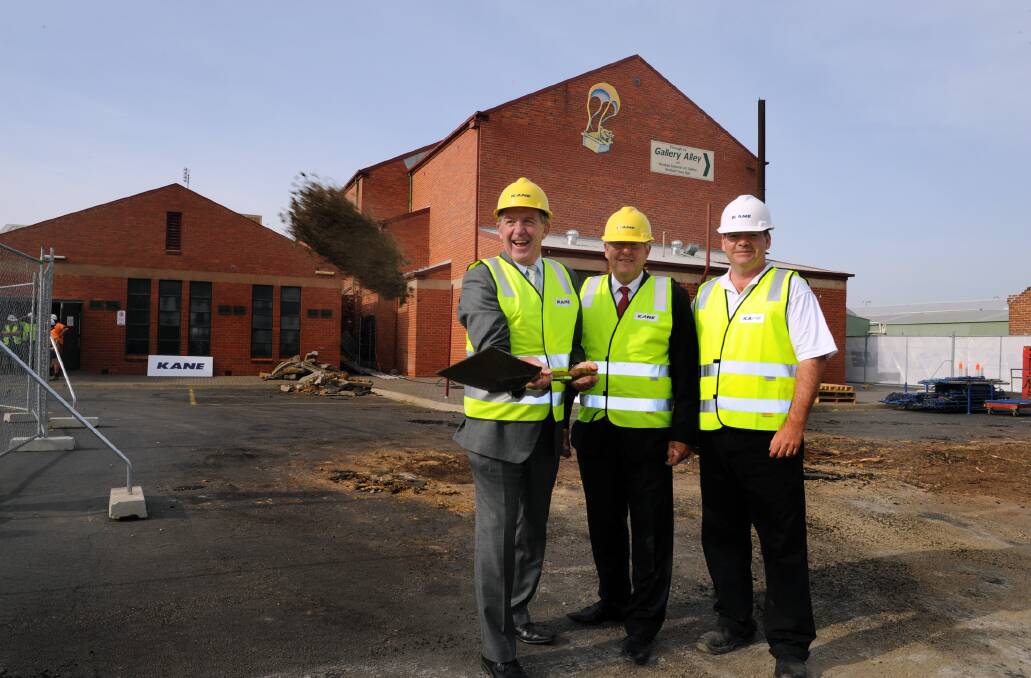 REDEVELOPMENT: Member for Lowan Hugh Delahunty, Horsham Mayor David Grimble and Kane Constructions project manager Peter Mann send the first sod flying at the town hall redevelopment construction site on Wednesday. Picture: PAUL CARRACHER
