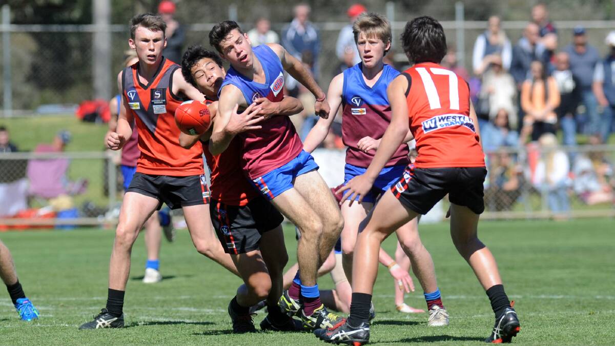 STATUS QUO: Stawell's Jarrod Illig tackles Horsham's Ryan Kemp in the 2014 Wimmera Football League under-17 grand final. The league's junior football structure remains the same this year. Picture: PAUL CARRACHER
