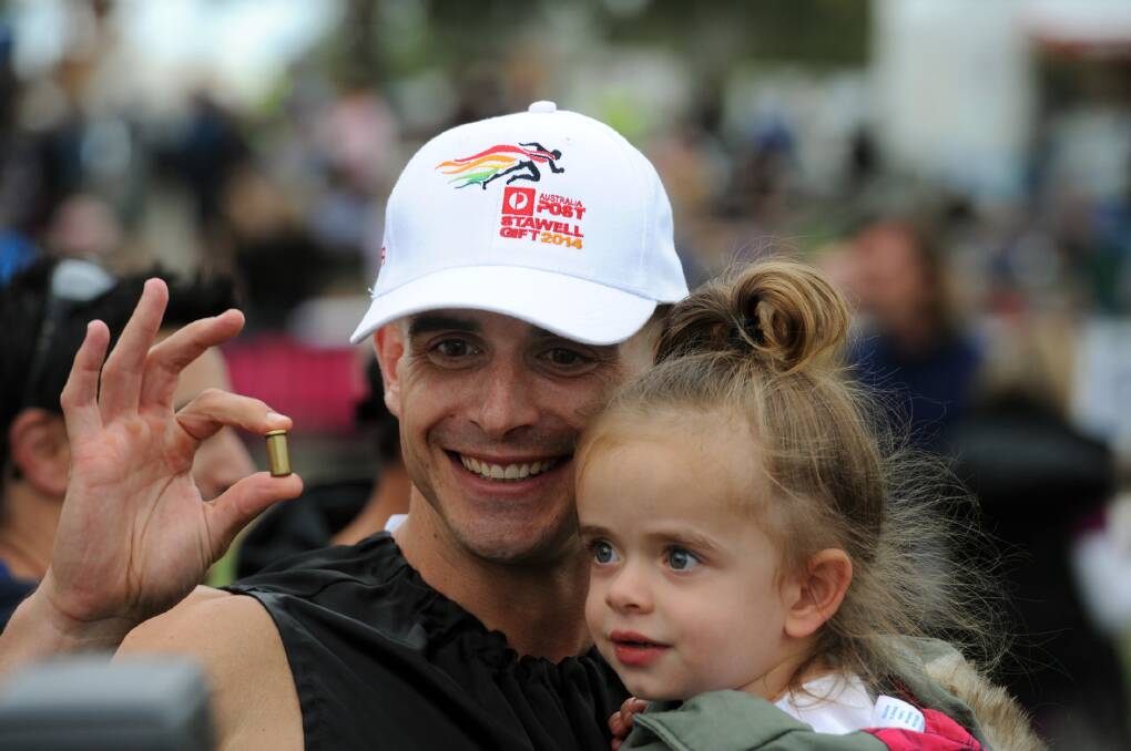 Luke Versace, black, wins the 2014 Stawell Gift. Pictured with his niece Charlotte Versace. 