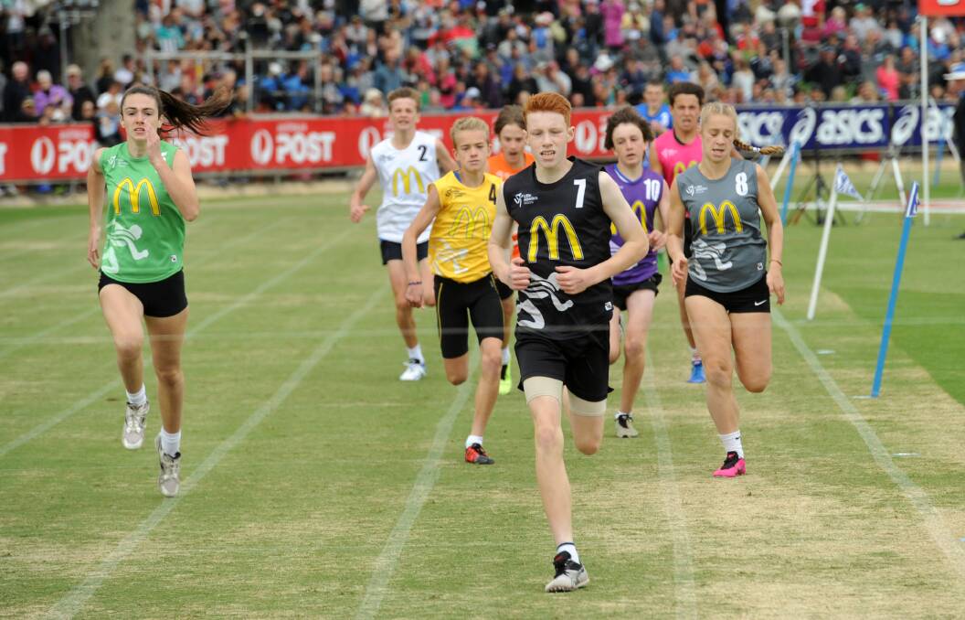 Luke Mitchell wins the Little Athletics 400m. Horsham's Anna Bush on the left. 
