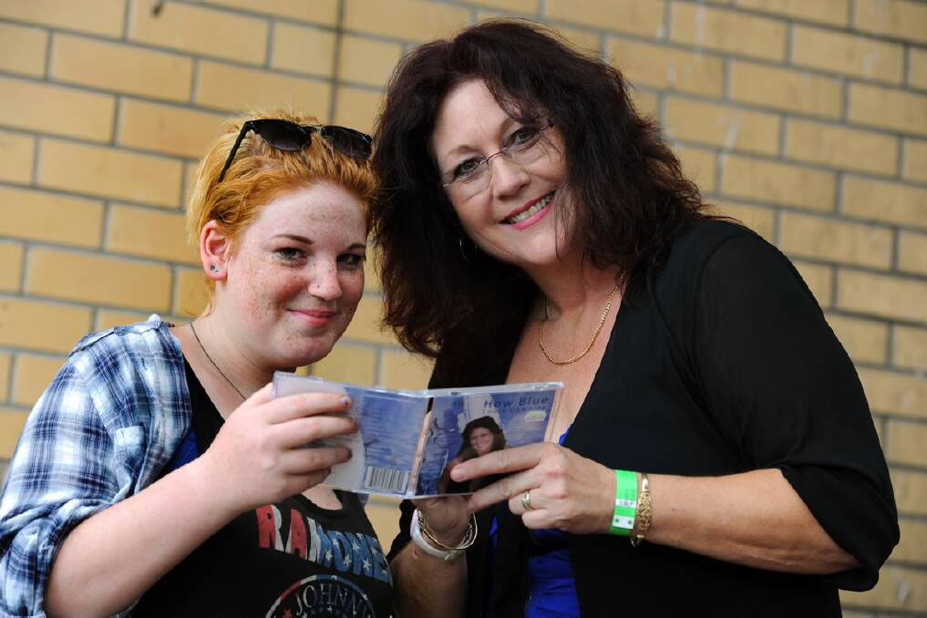 HAPPY: Haley Brown of Geelong gets an autographed copy of singer Laura Downing's CD at the Lake Charlegrark Country Music Marathon.