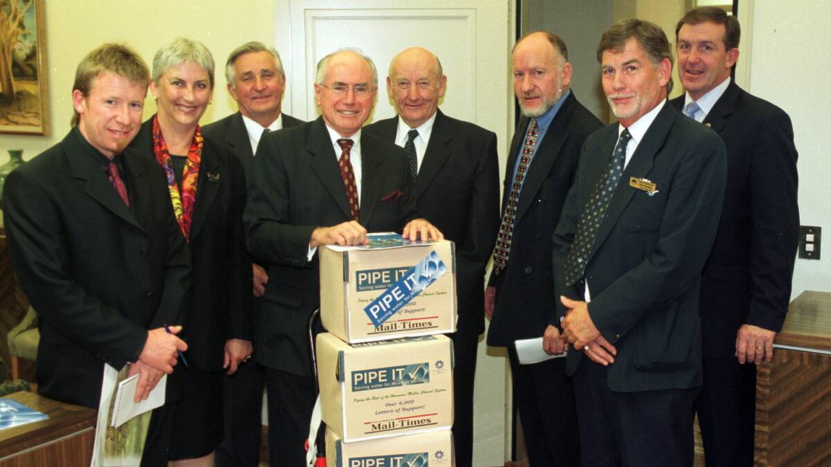 Danny Lannen, Jo Bourke, Lance Netherway, John Howard, Stewart Petering, John Forrest, John Konings and Hugh Delahunty with pipeline petition in 2002. 