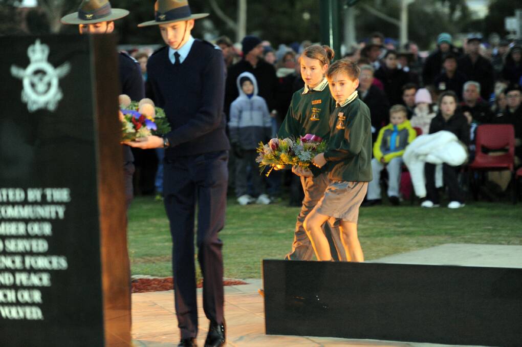 Ss Michael and John's Primary School captains Madeline Arnel and Sam O'Connor lay a wreath at Horsham Anzac Day dawn service. 
