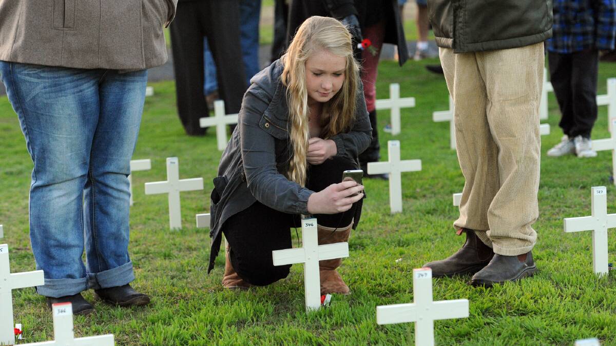Abbey Ballinger at the cross of her Great Uncle Albert Taylor at Horsham Anzac Day dawn service. Pictures: PAUL CARRACHER