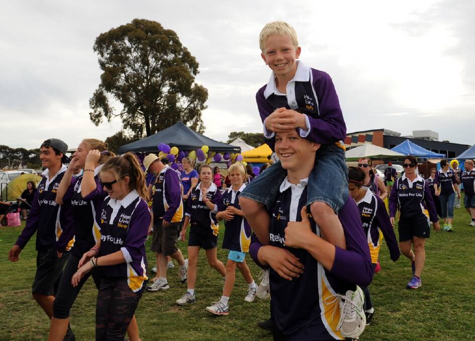 Ben Walker, 9, gets a lift from Cody Cardwell at Horsham Relay For Life. 