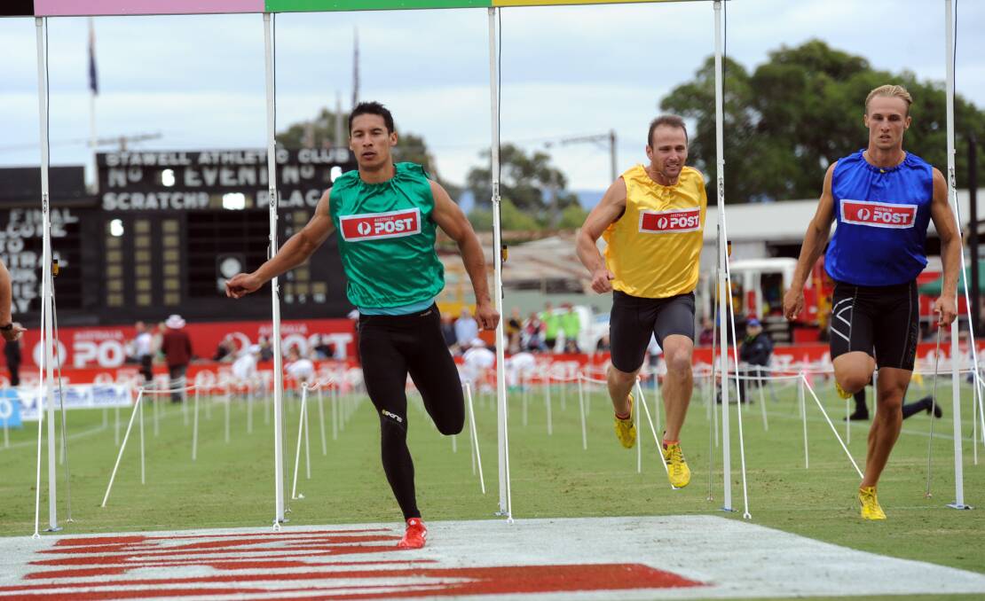 Ed Ware, green, wins heat 6 of the 2014 Stawell Gift. 