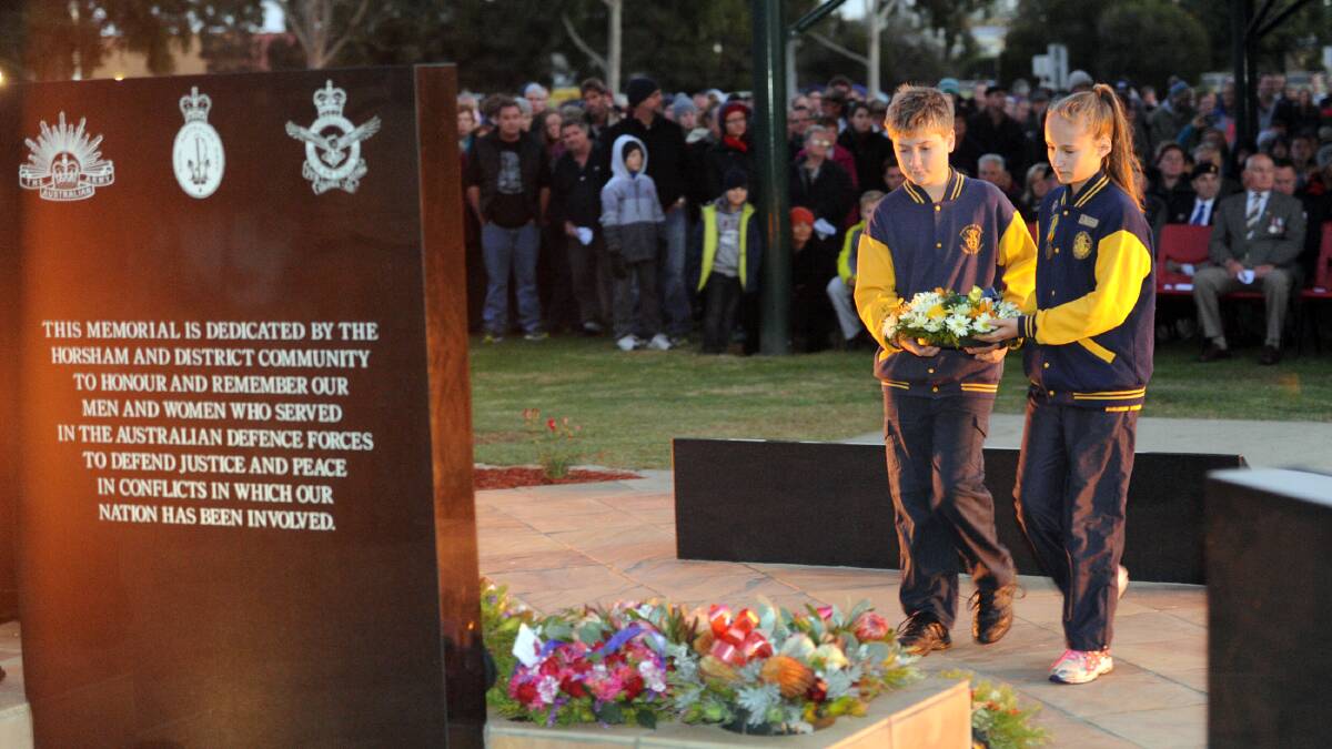 Horsham West captains Cade Dodson and Emily Russell lay a wreath at Horsham Anzac Day dawn service. 